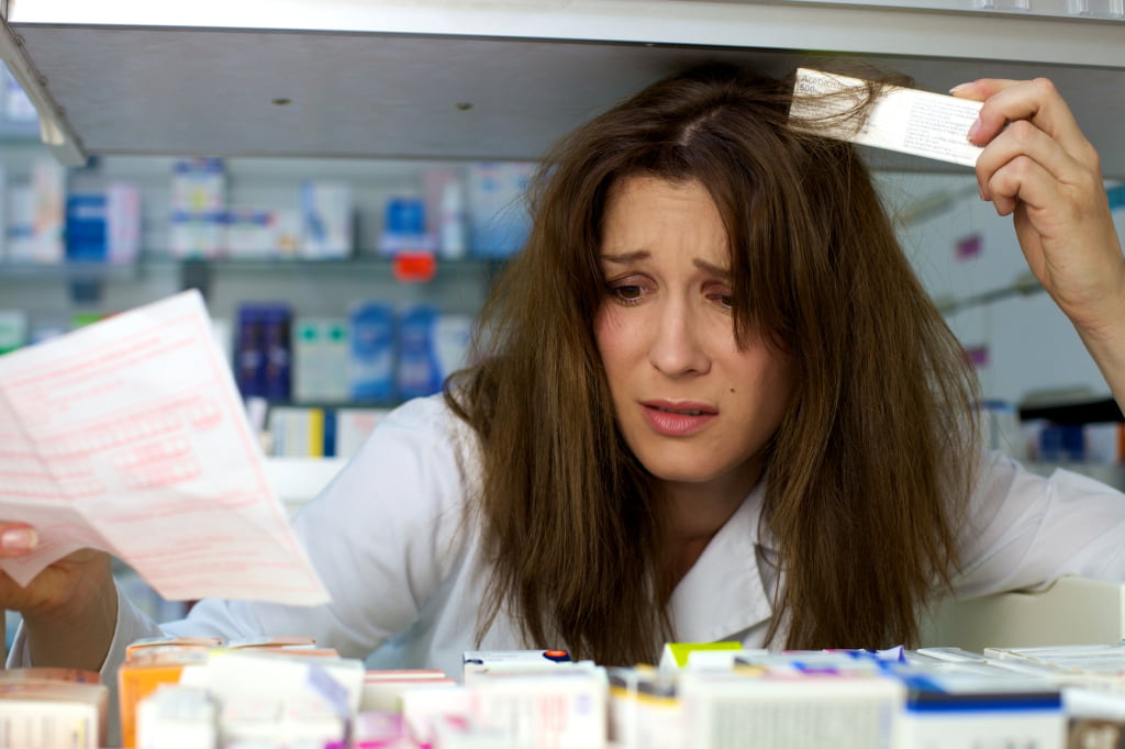 woman pharmacist stressed about not finding medicine