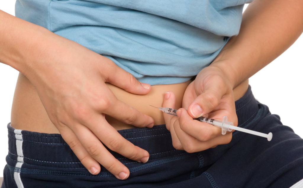 Girl giving herself insulin shot