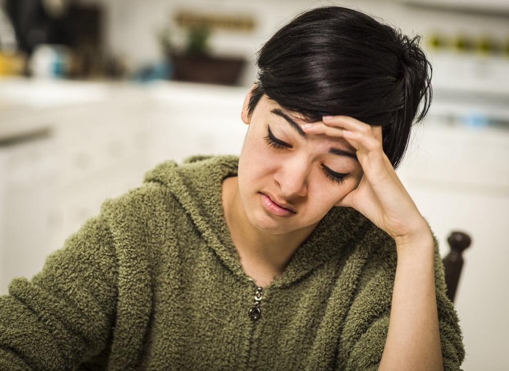 stressed looking woman a desk