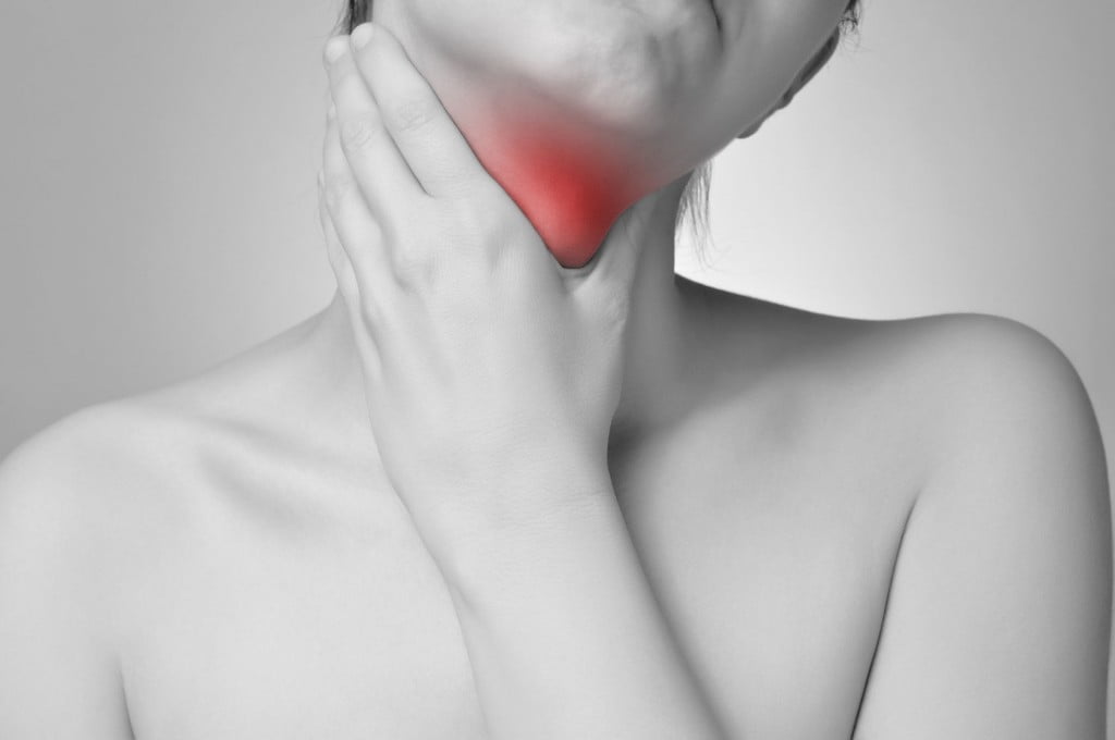 Woman holding her throat