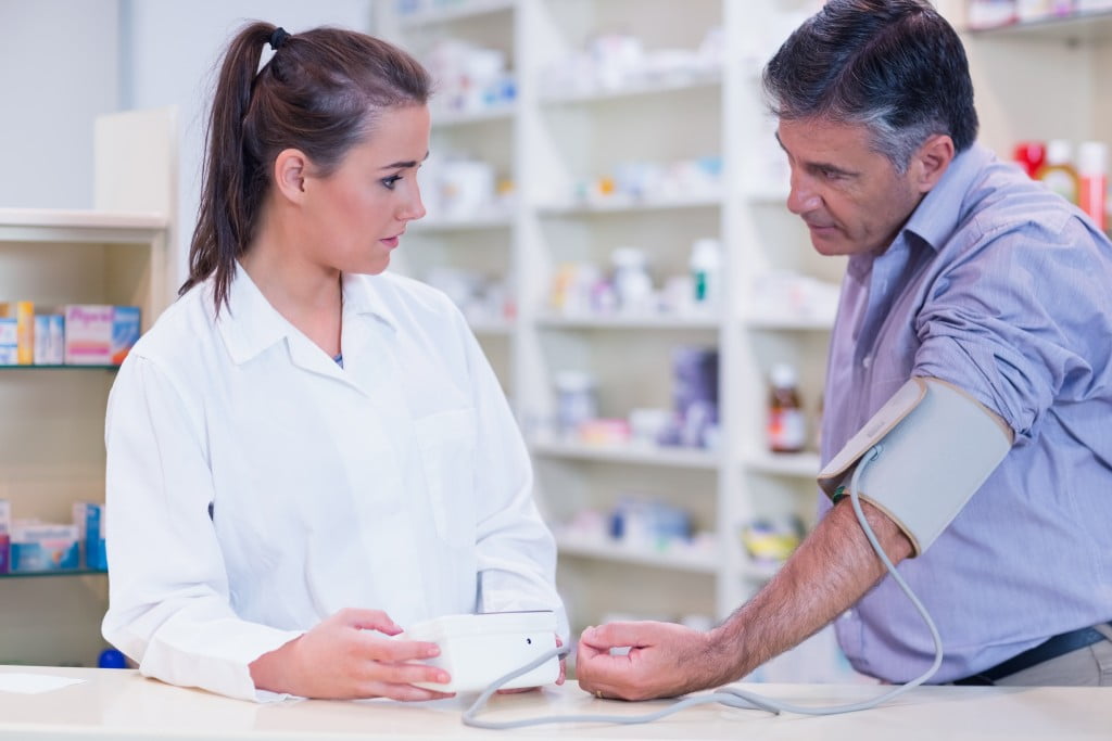 pharmacist doing blood pressure check