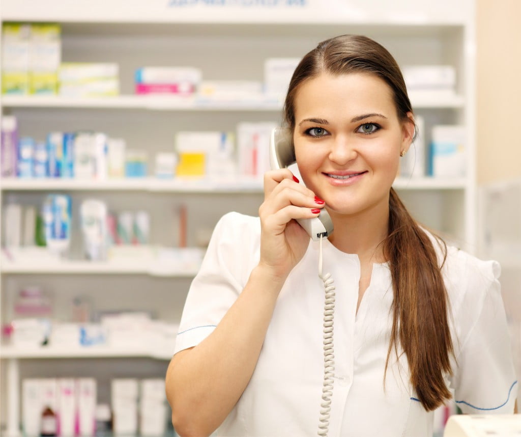 Pharmacists' Support Service: young pharmacist on the phone, smiling