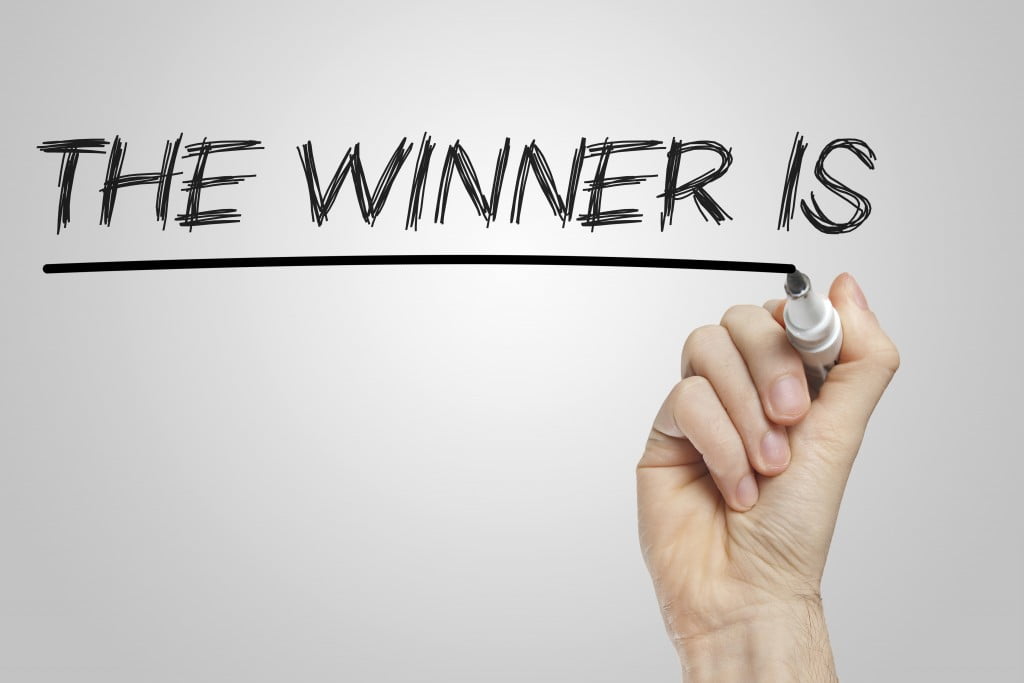 Hand writes "and the winner is"