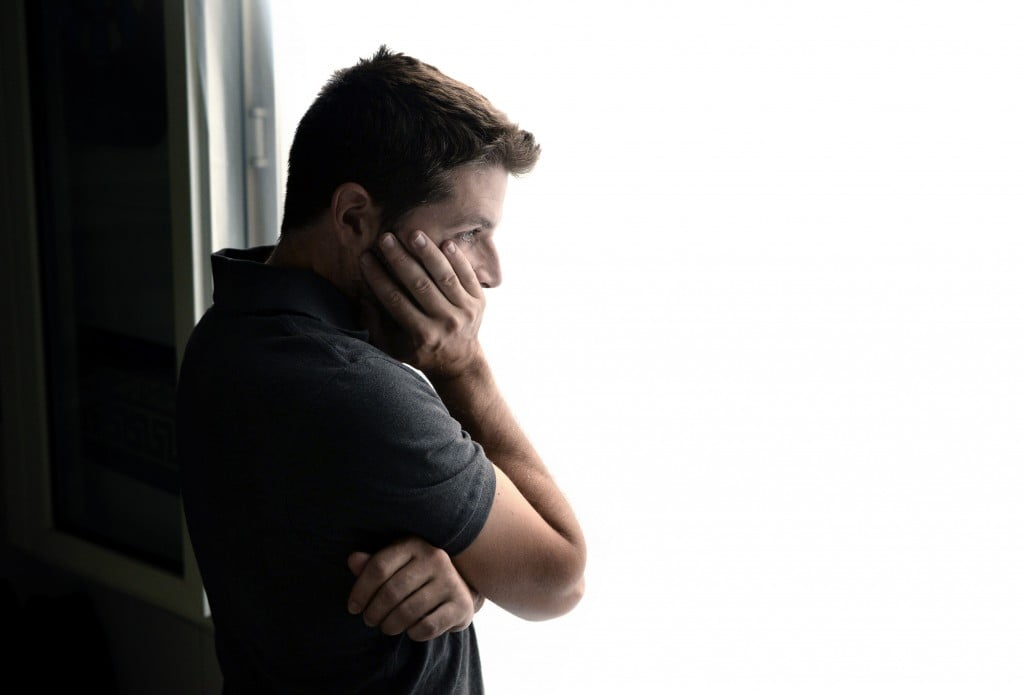 Dementia: man stares sadly out window