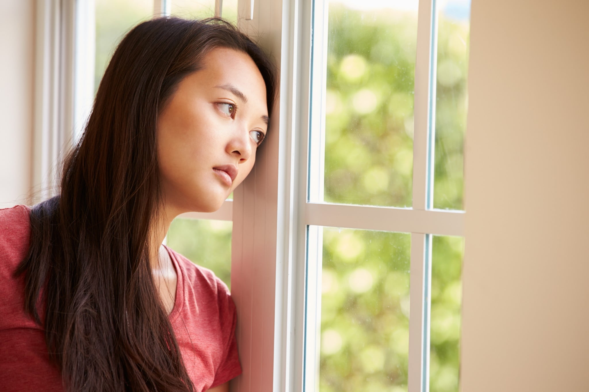 woman gazes out of window