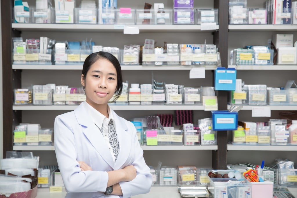 happy pharmacist in dispensary