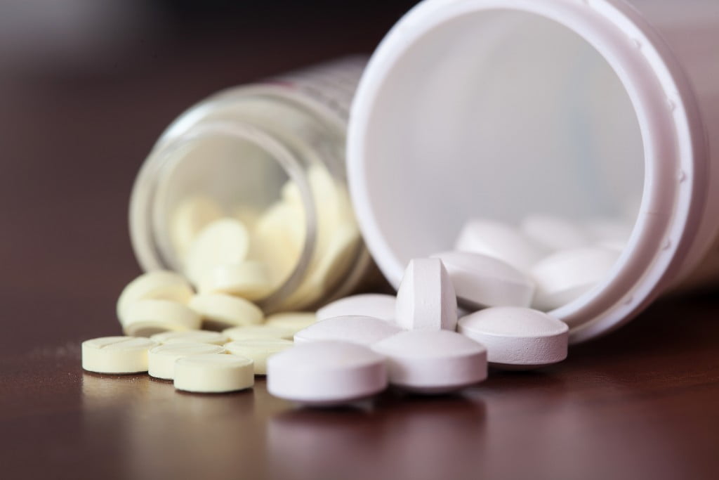 S3 analgesics - white pills spill from two bottles