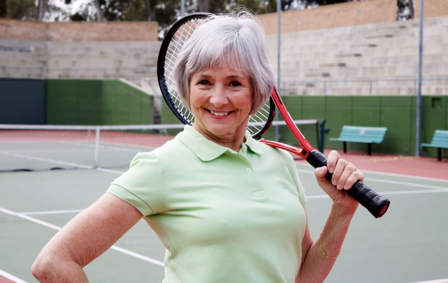 elderly woman with tennis racket