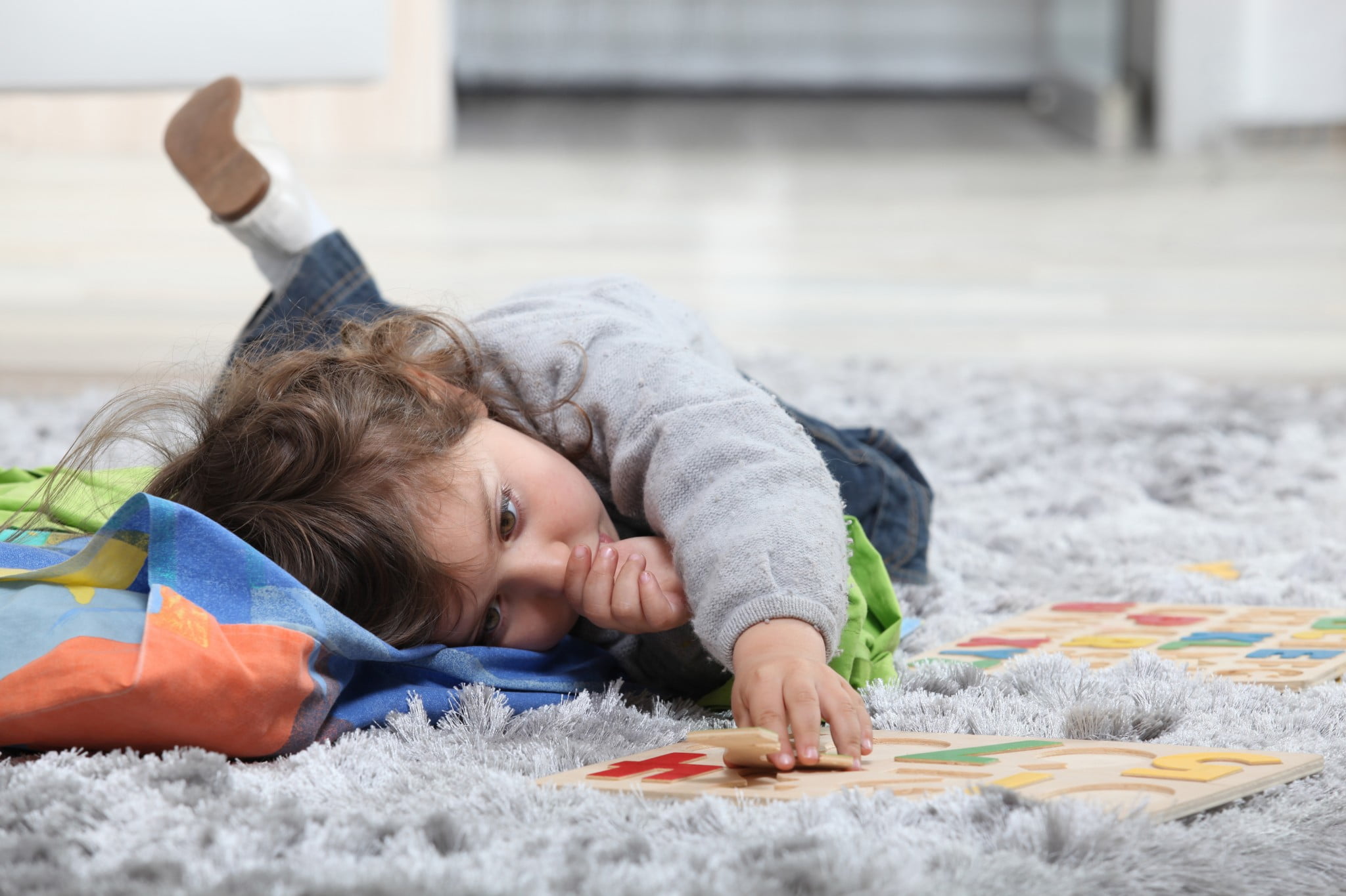 toddler plays on grey shag rug