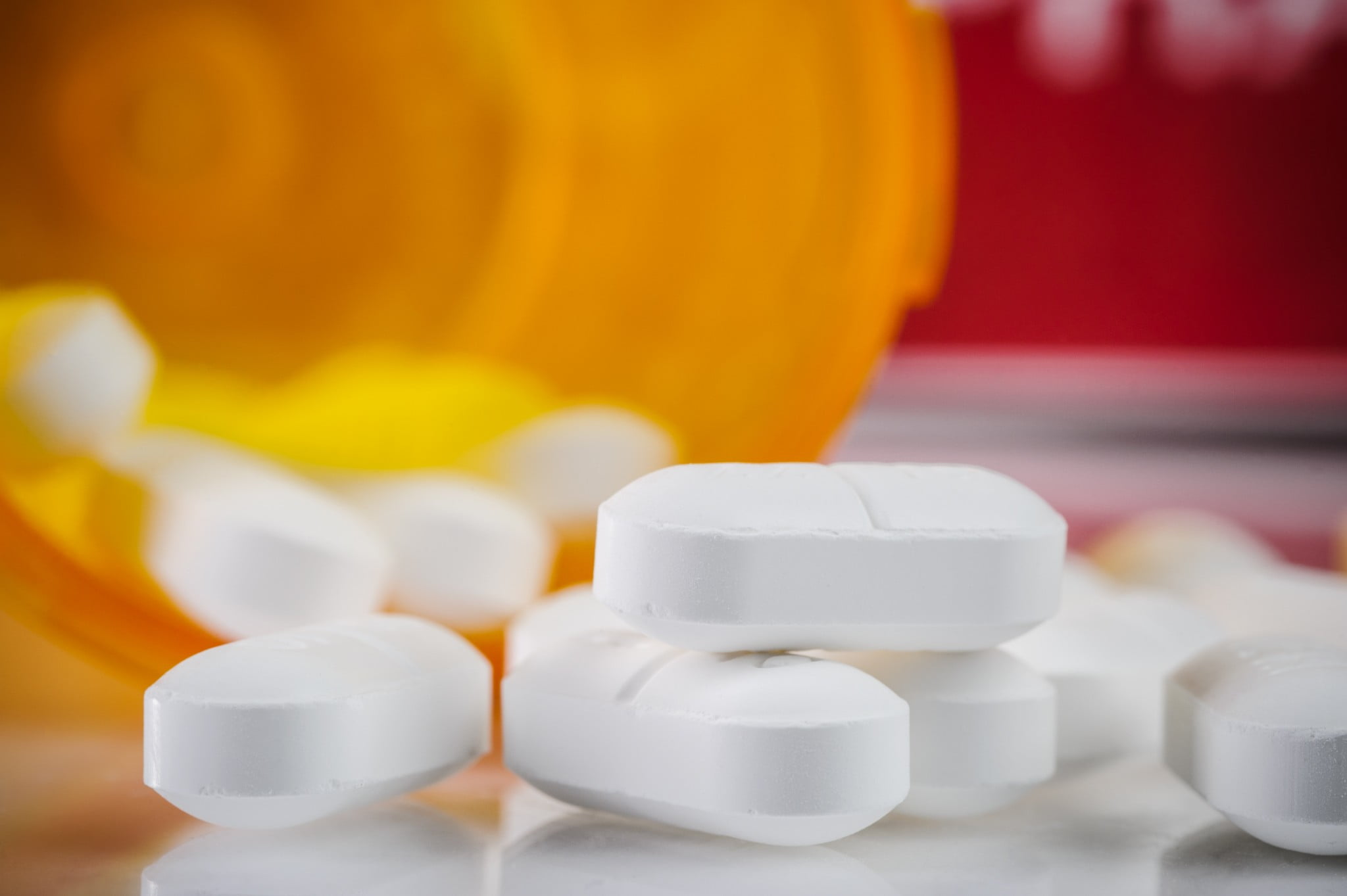 codeine tabsules spill from orange pill bottle