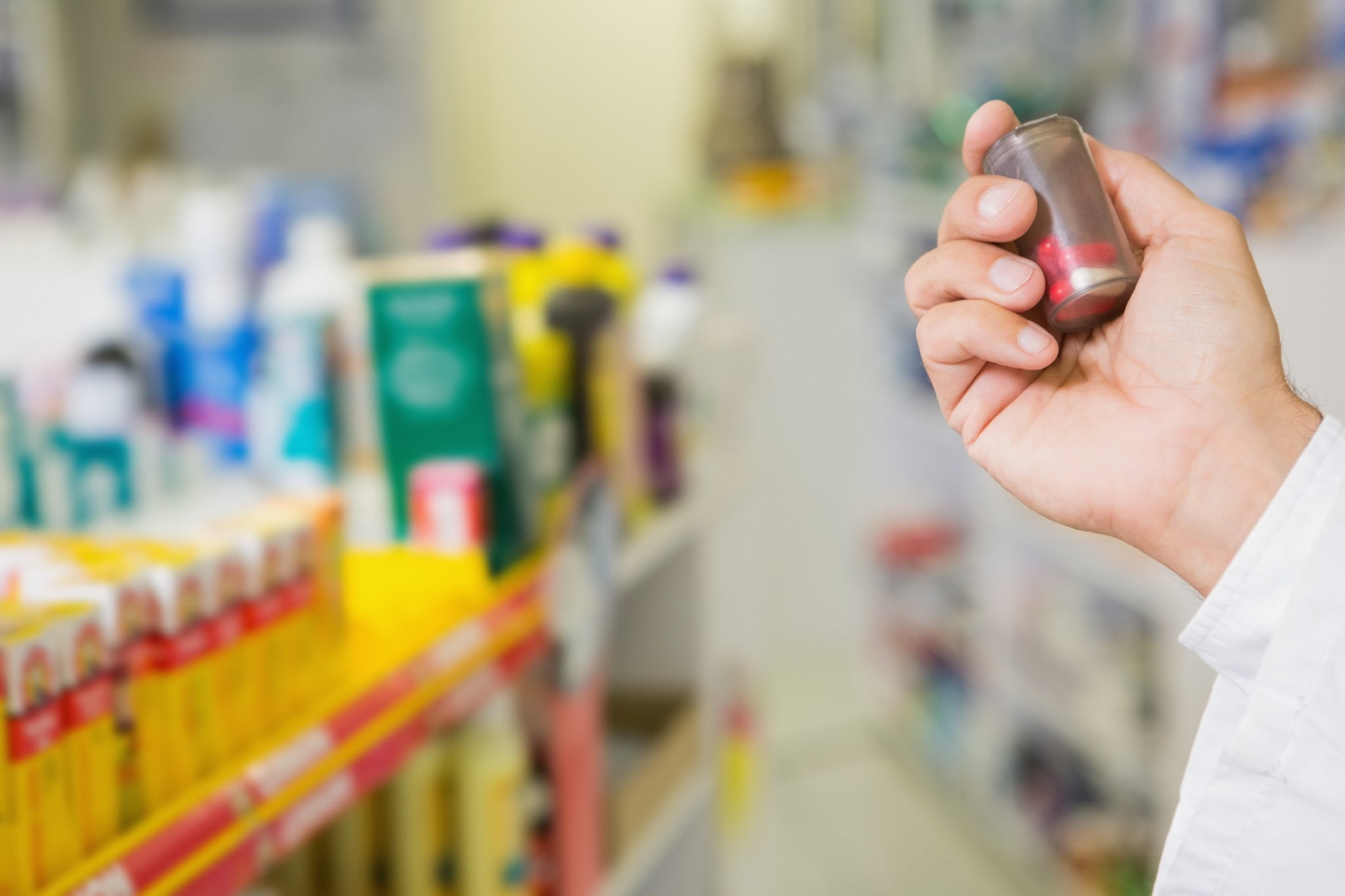 pharmacist holds up bottle