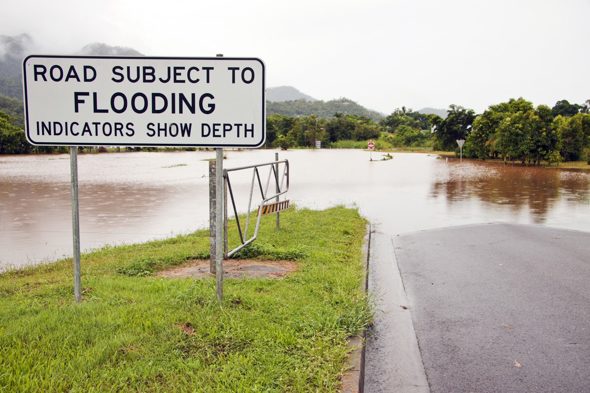 mould risk: flood sign by flooded road