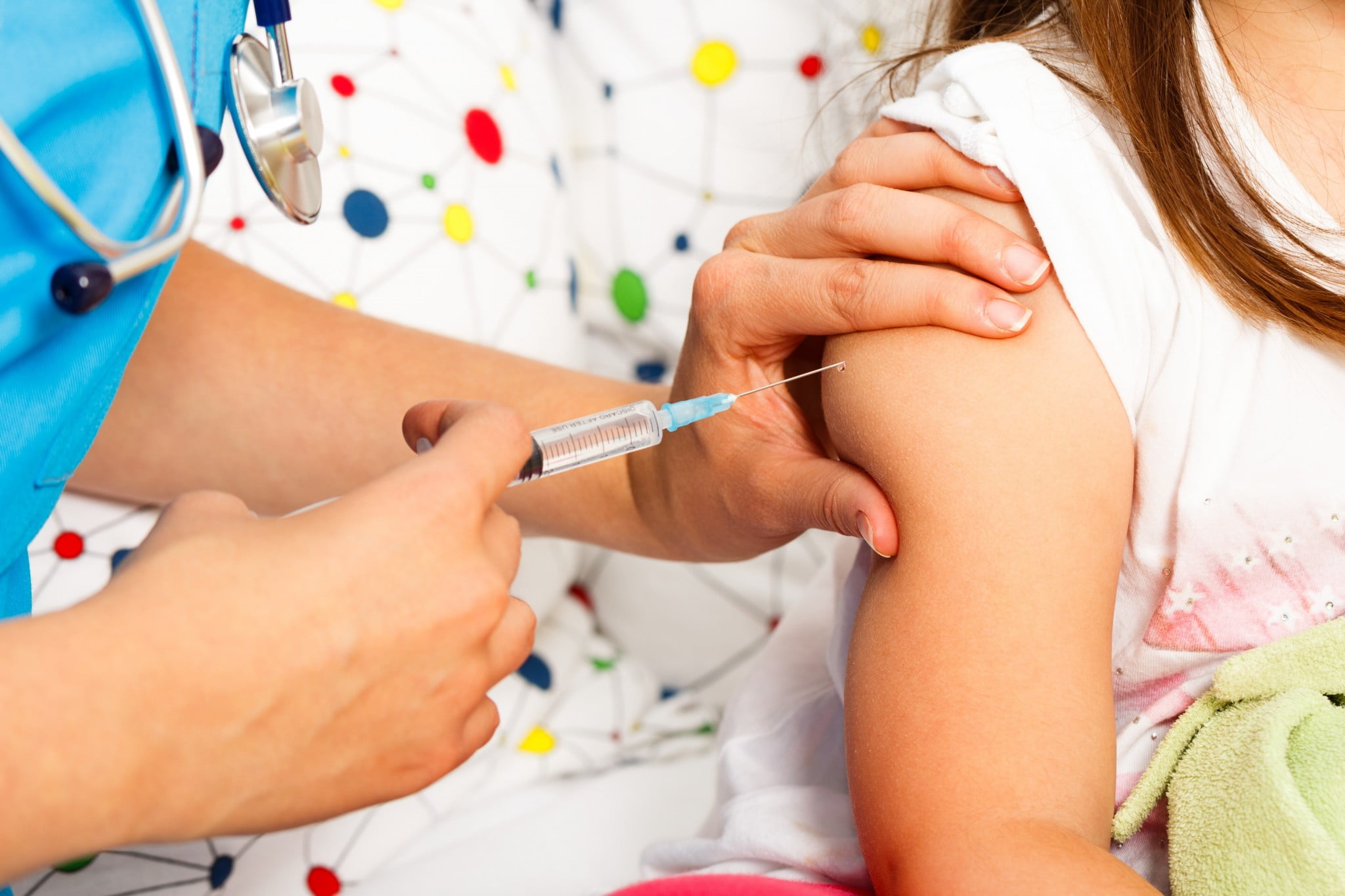 vaccine refusal: jab goes into child's arm