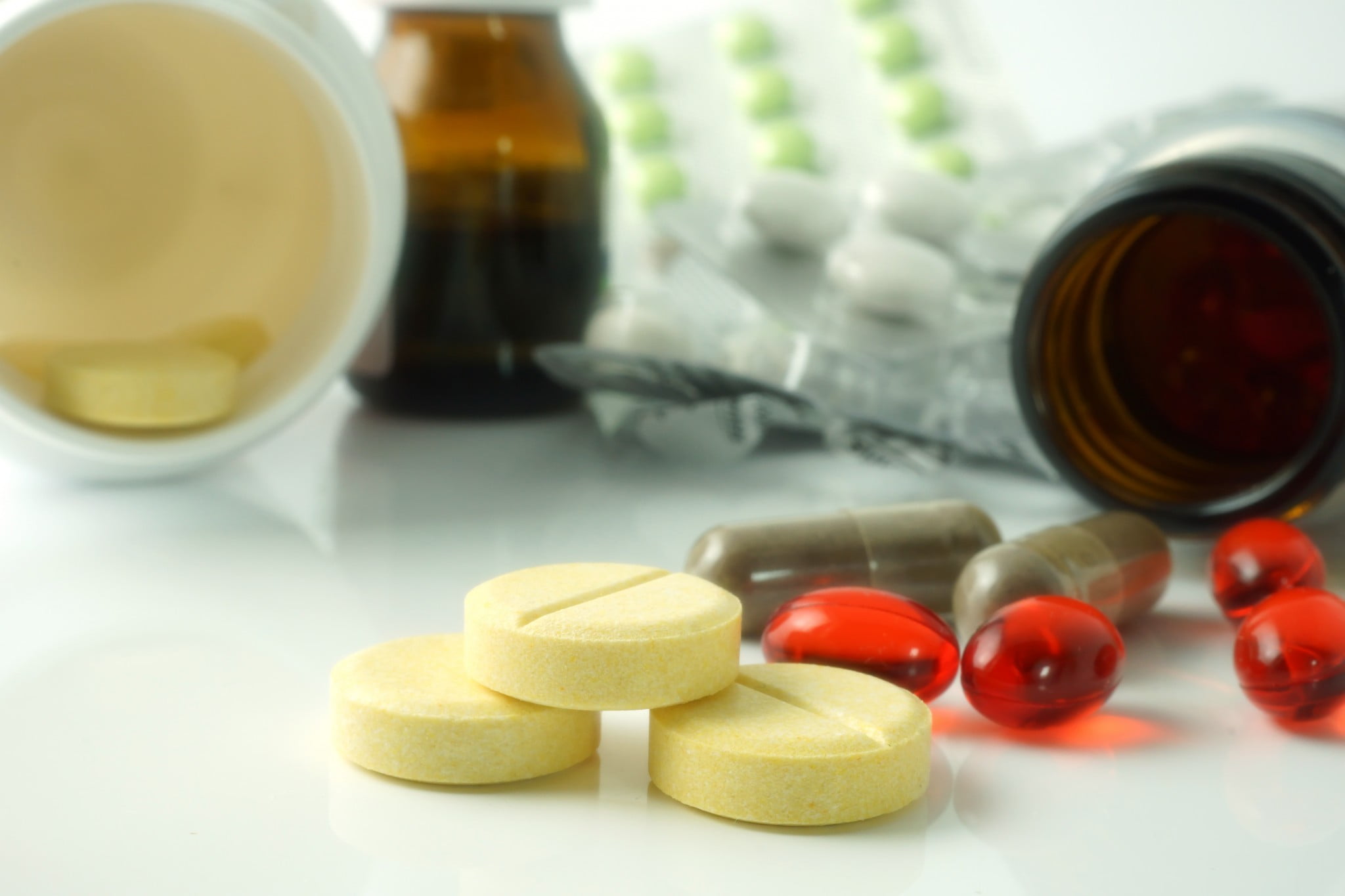 vitamins and minerals spill from bottles and packets