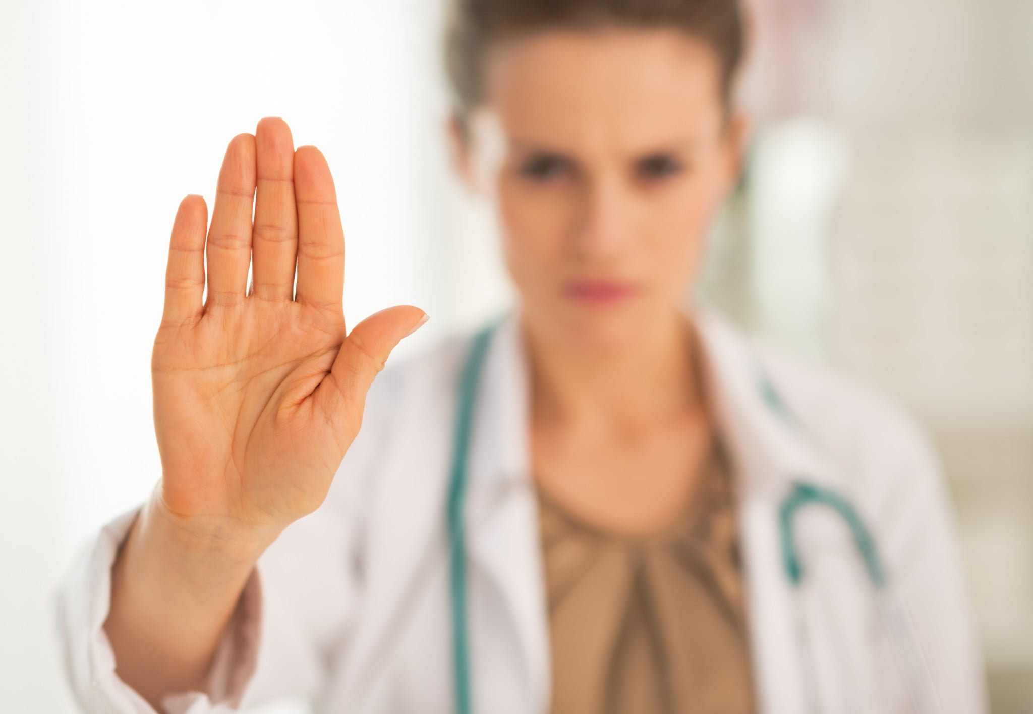 doctor makes "stop" gesture with hand - ama