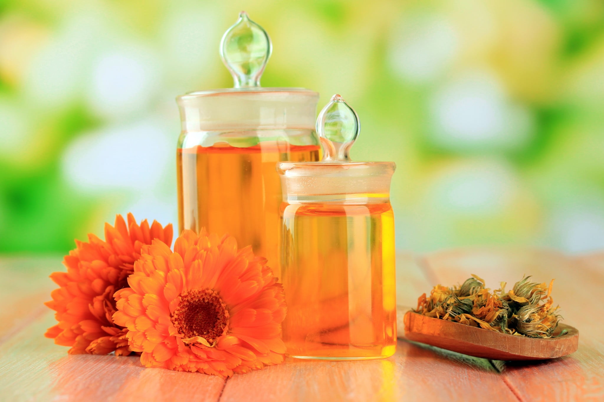 homeopathic products - jars of orange liquid and some flowers