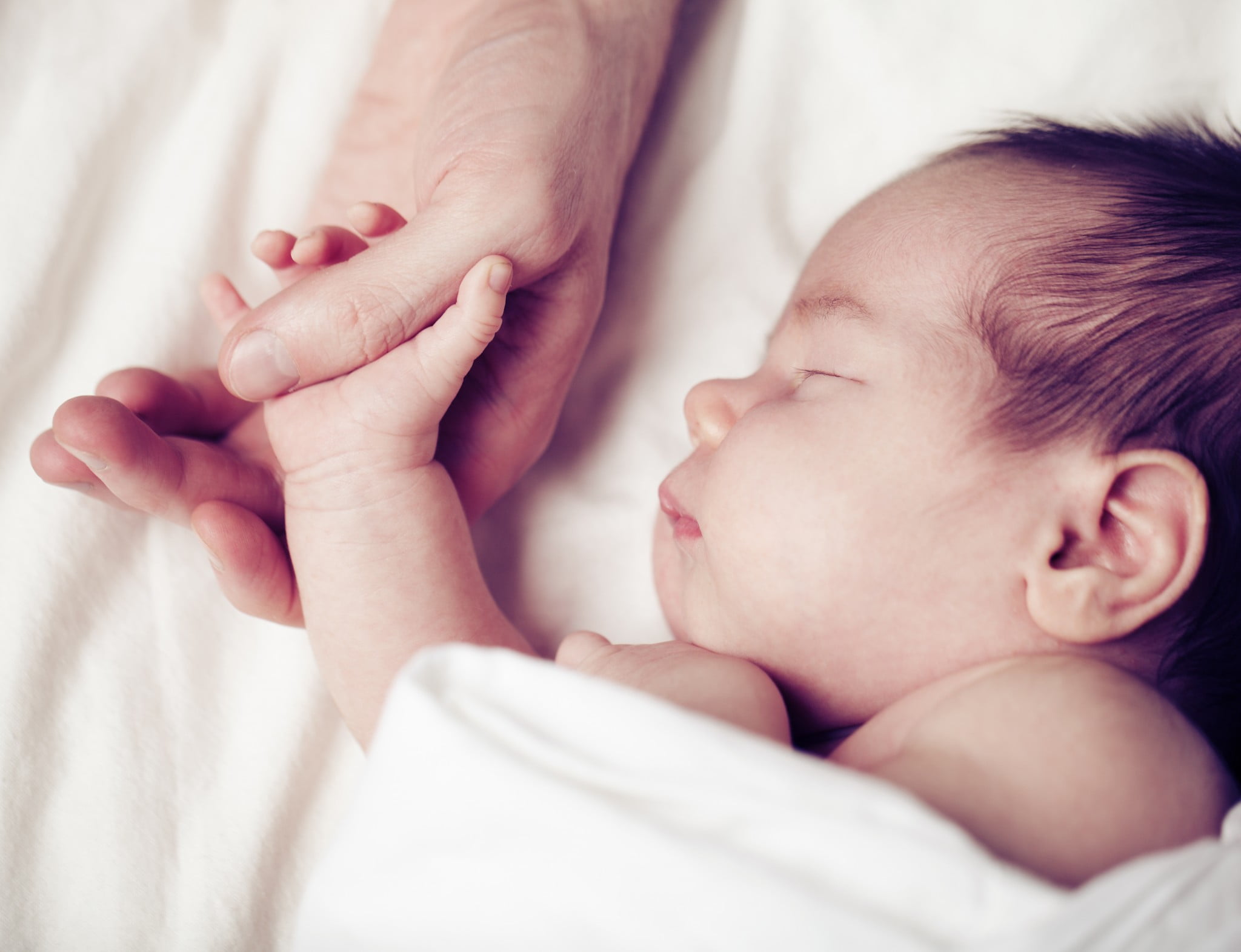Babies who snore: baby asleep holding father's hand