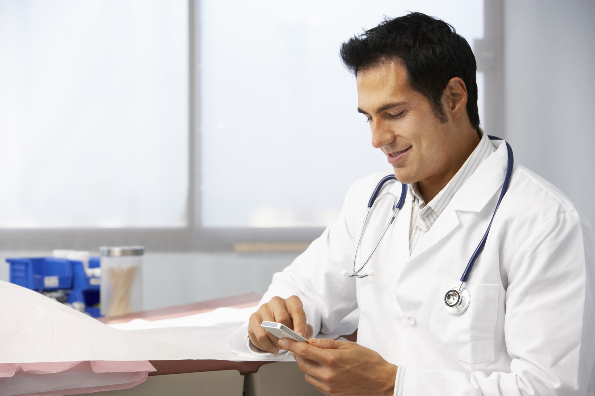 cancer trials app story: male doctor using smartphone