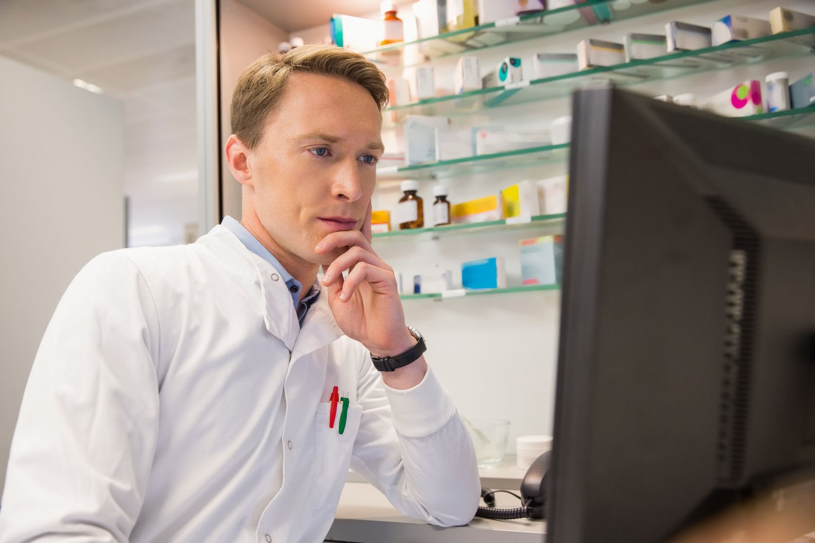 pharmacists sitting at a computer