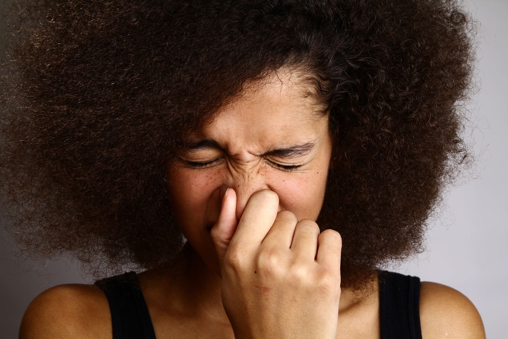 woman sneezing - cold or allergy