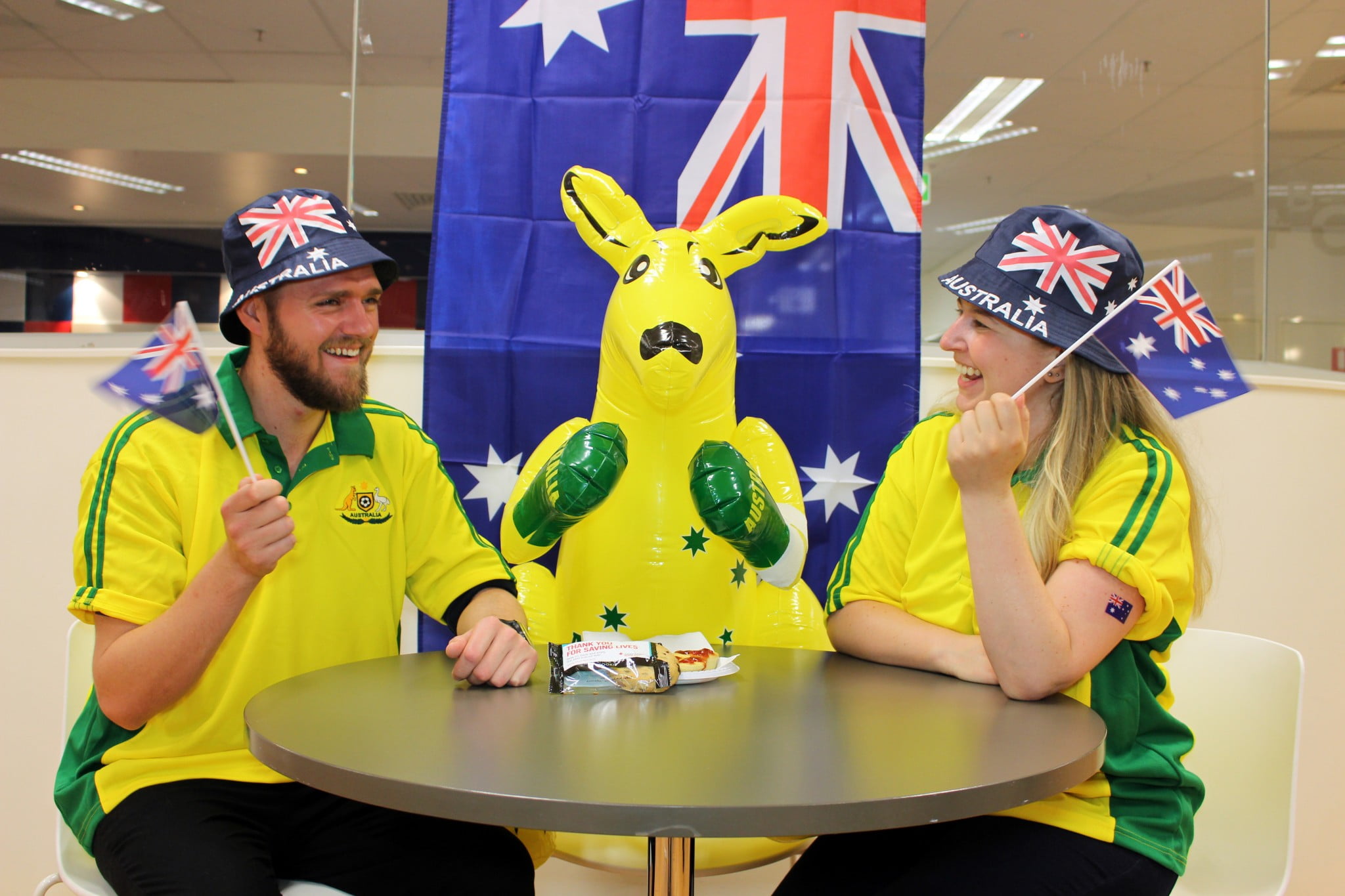 Bleed for Australia, donors in green and gold with inflatable kangaroo waving flags