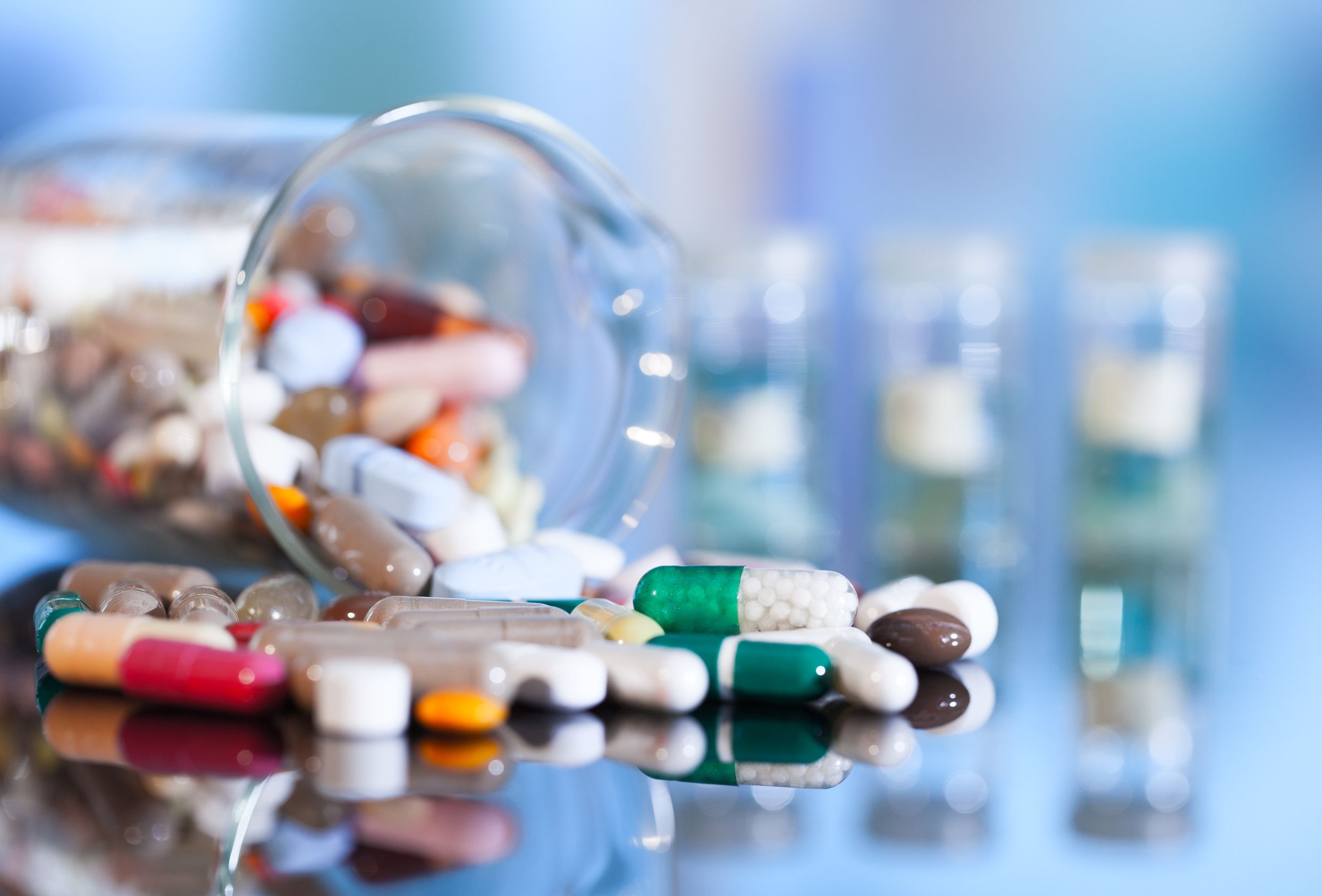 pills spill out of beaker