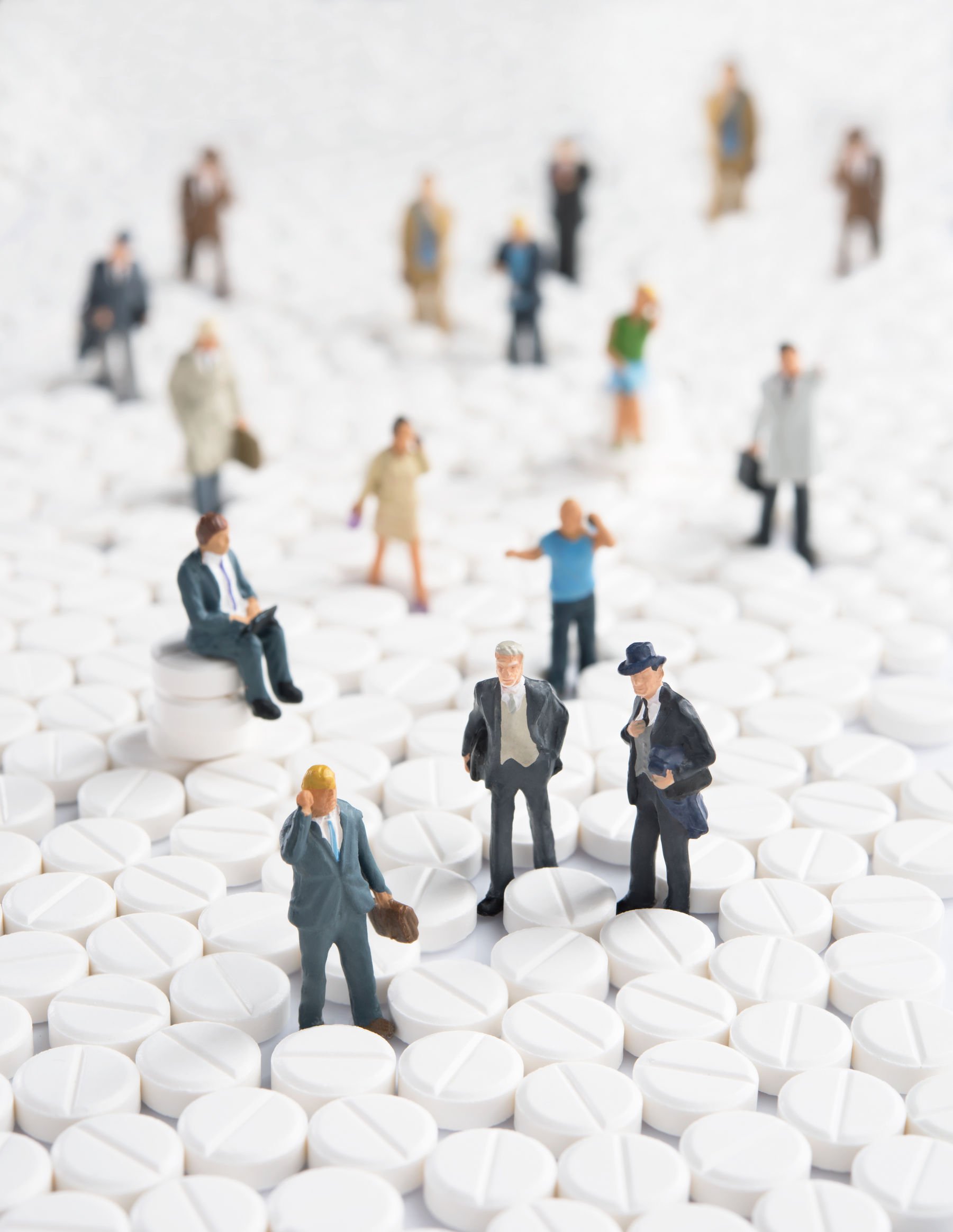 tiny health professionals among large pills