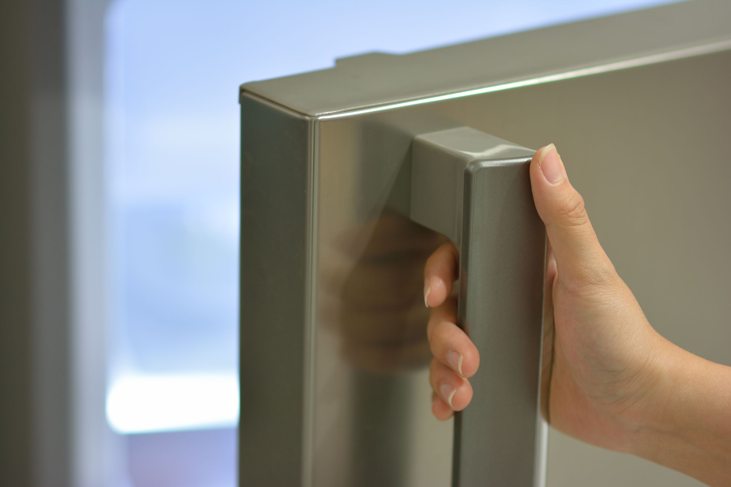 hand opening fridge door