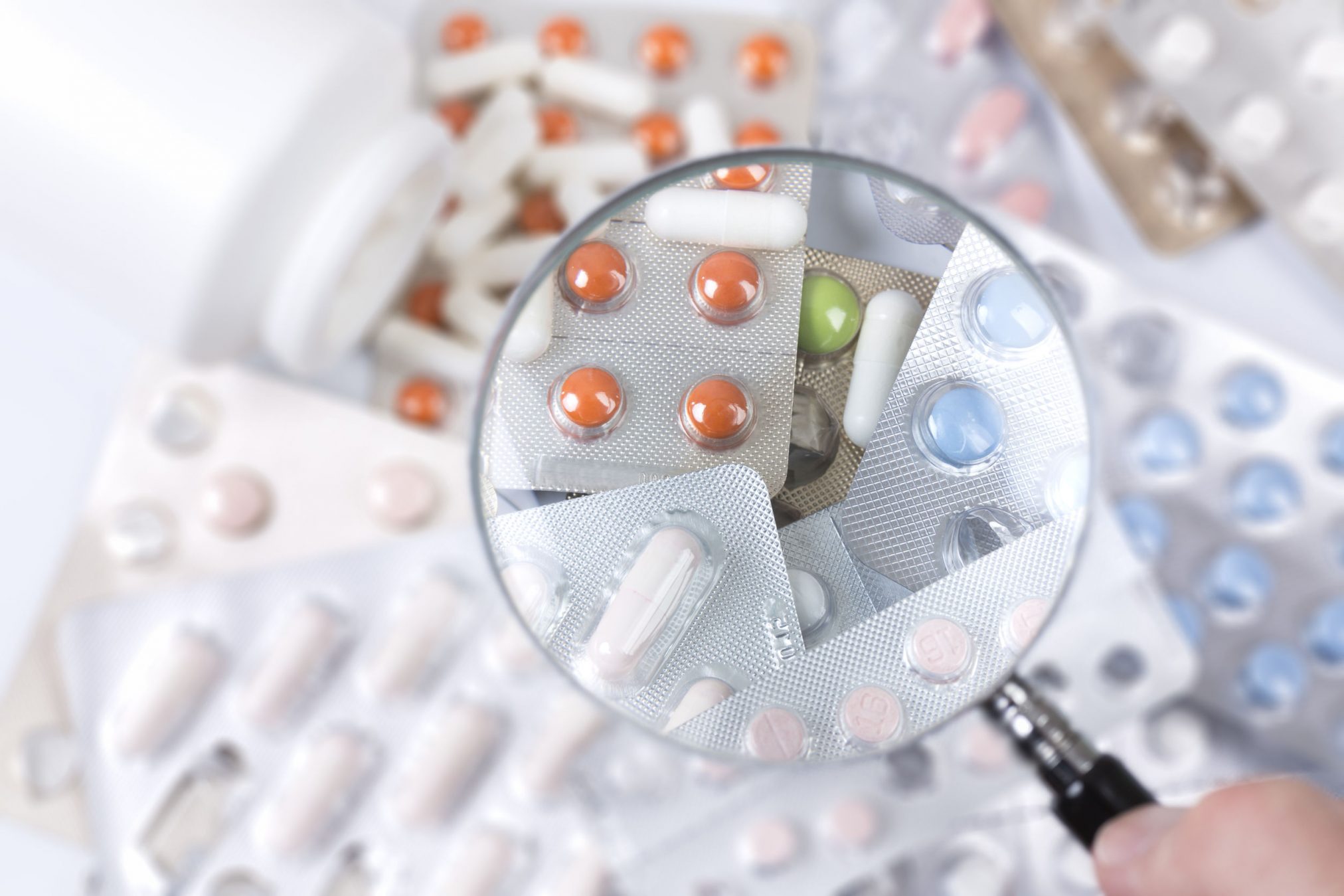medicines under magnifying glass