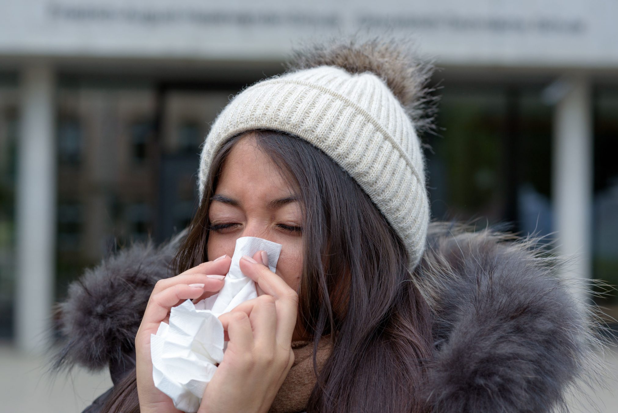 woman blowing her nose