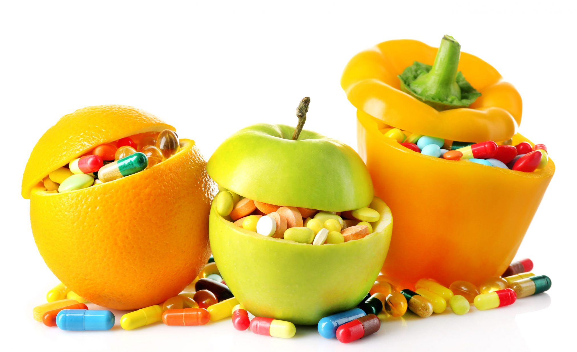 43984073 - orange fruit, apple and bell-pepper and colorful pills, isolated on white