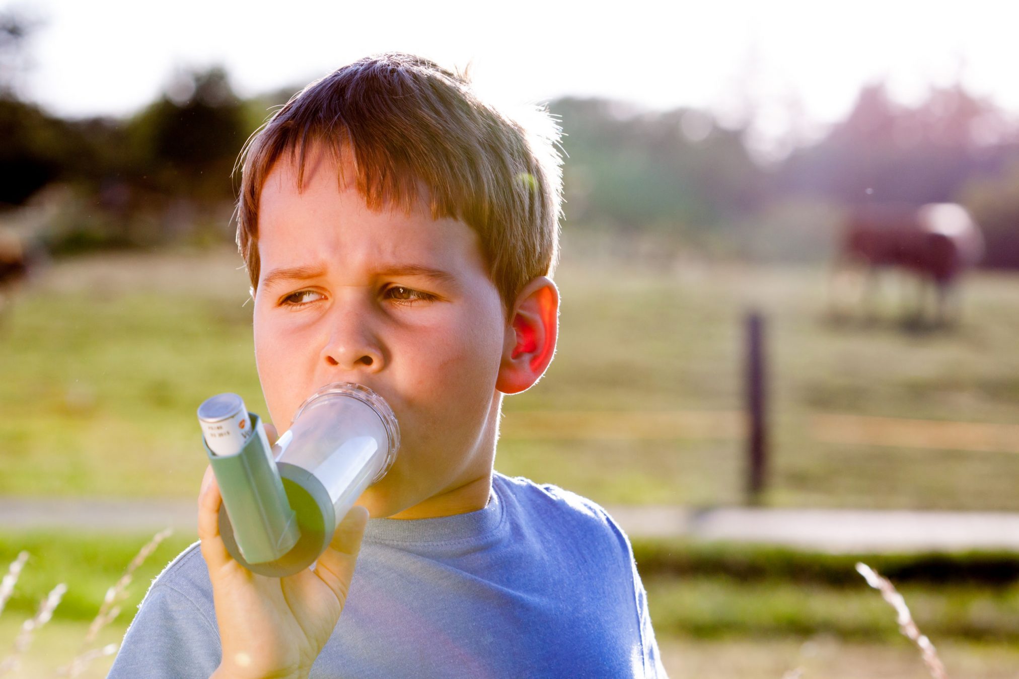 boy using inhaler and spacer