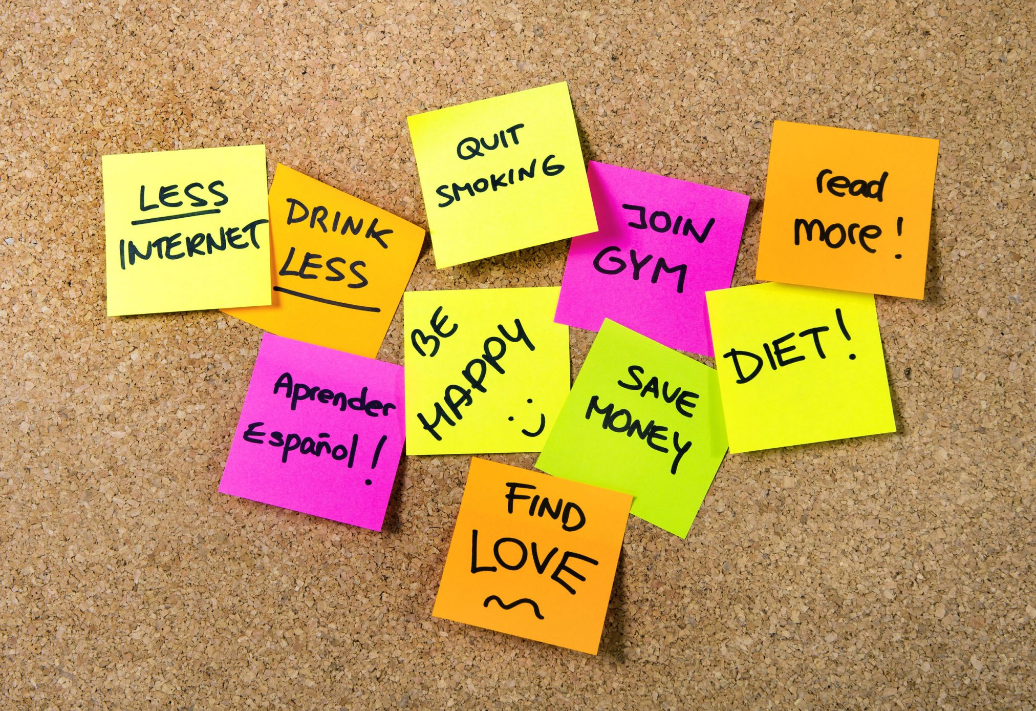 32657850 - group of new year resolutions post it notes on pink, yellow, orange and green on cork board written with message of diet, join gym, find love, quit smoking and be happy