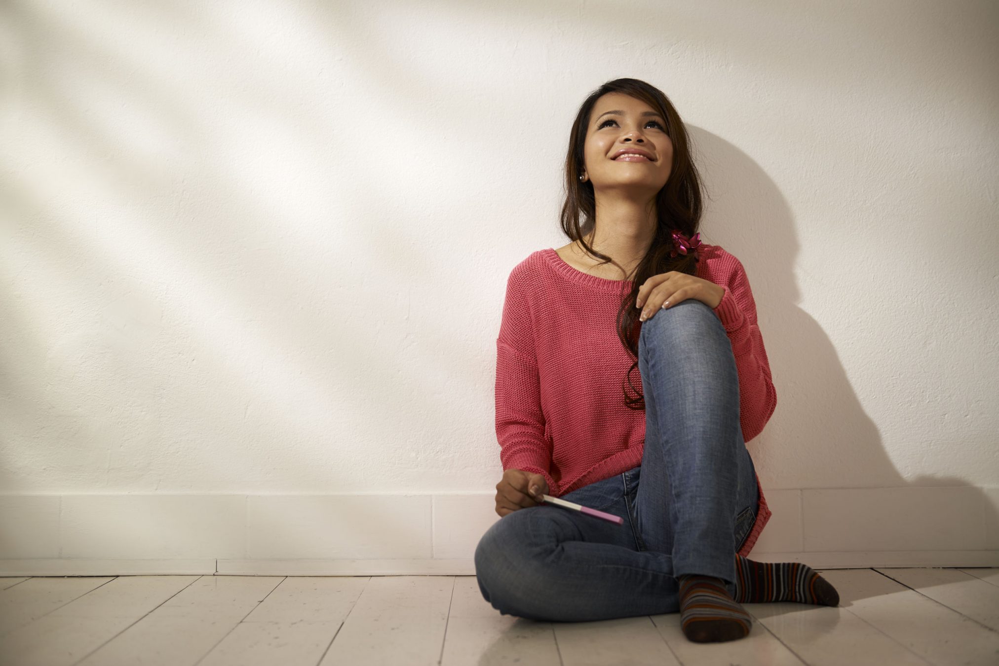 happy woman with pregnancy test