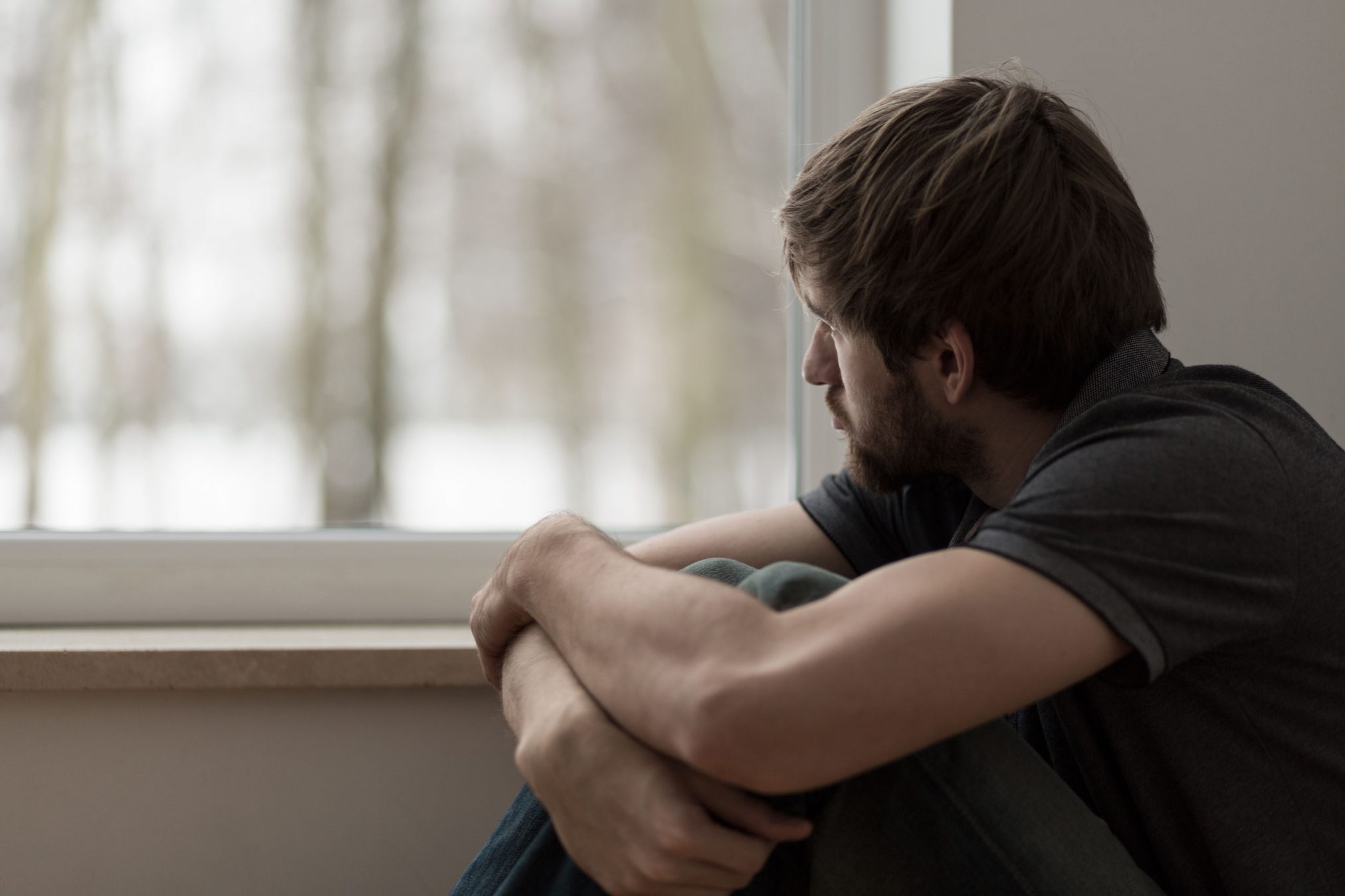 Sad man by a window