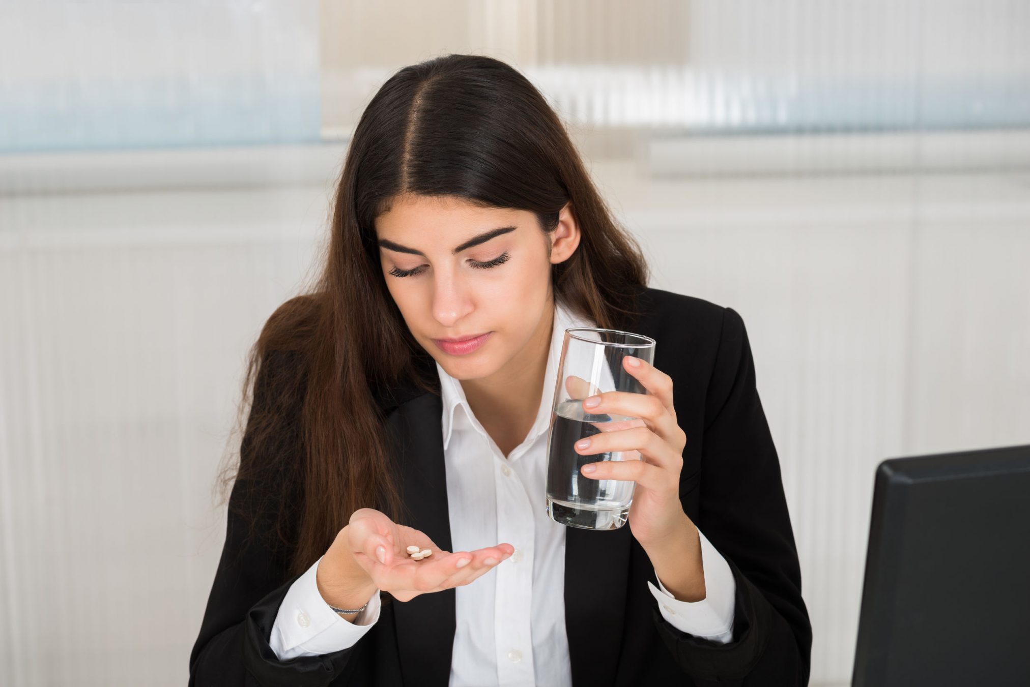 woman taking tablet