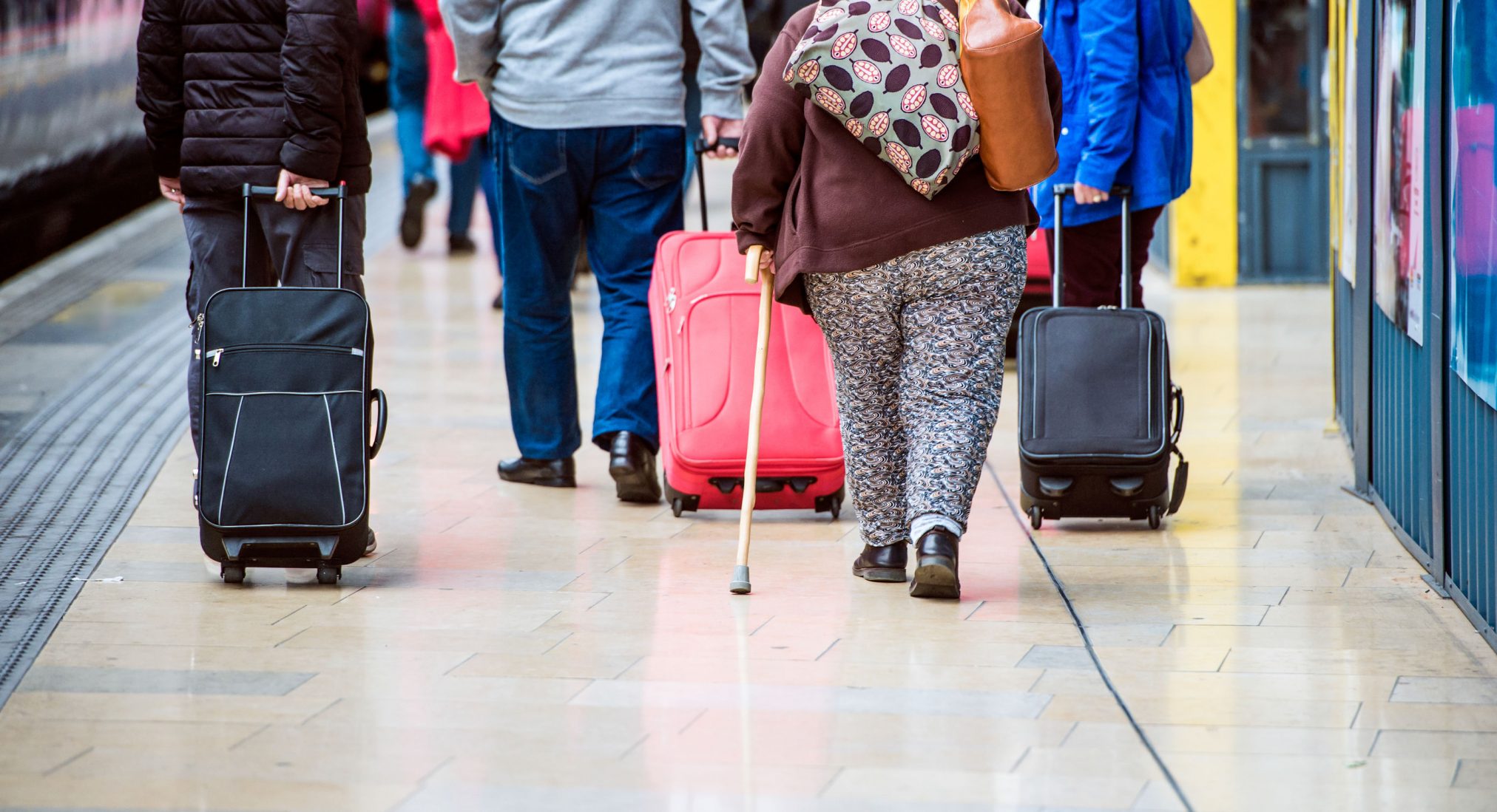 Overweight people walk through train station