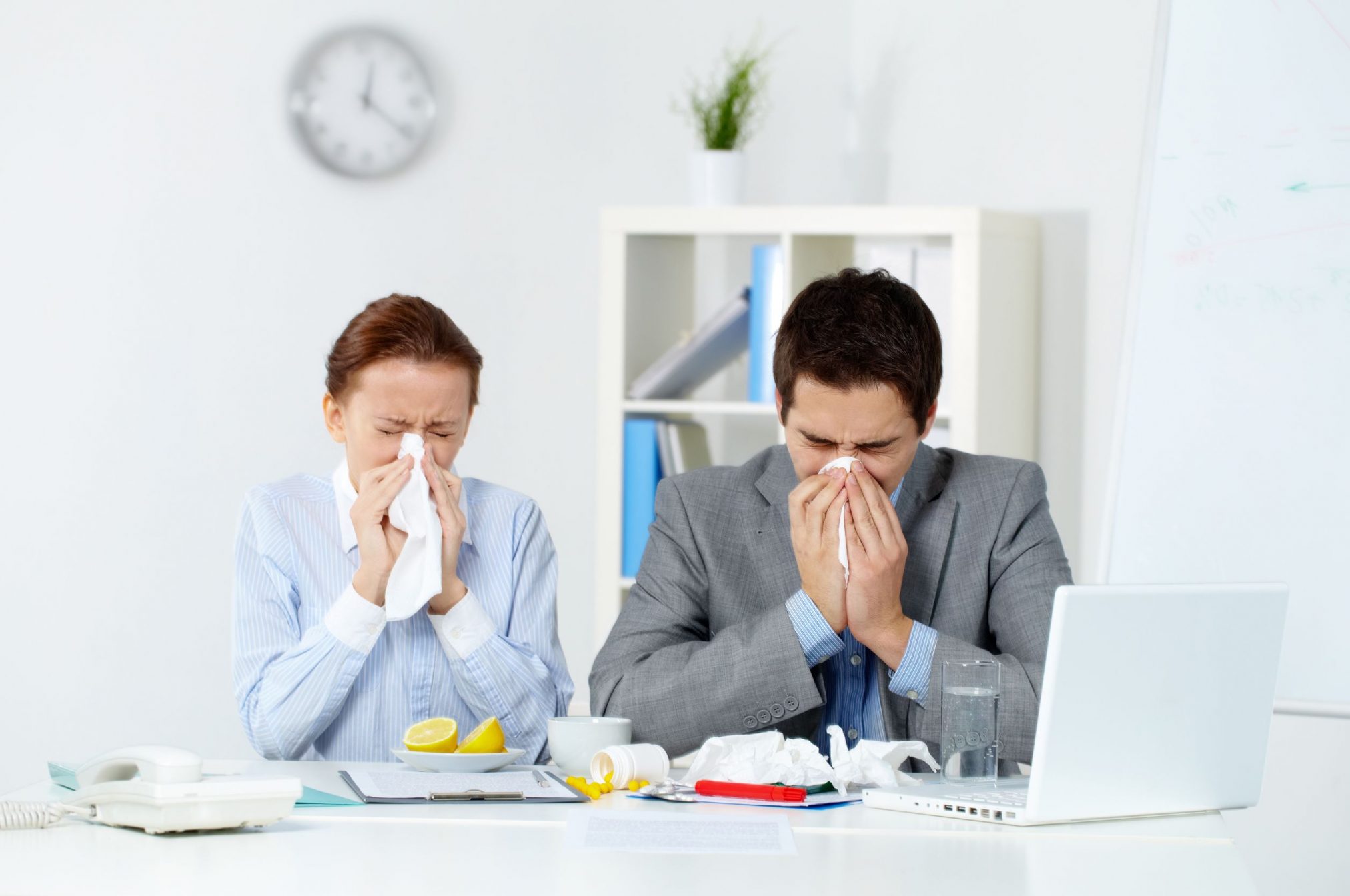 office workers blowing noses