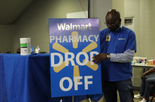 man readies the Walmart pop-up pharmacy