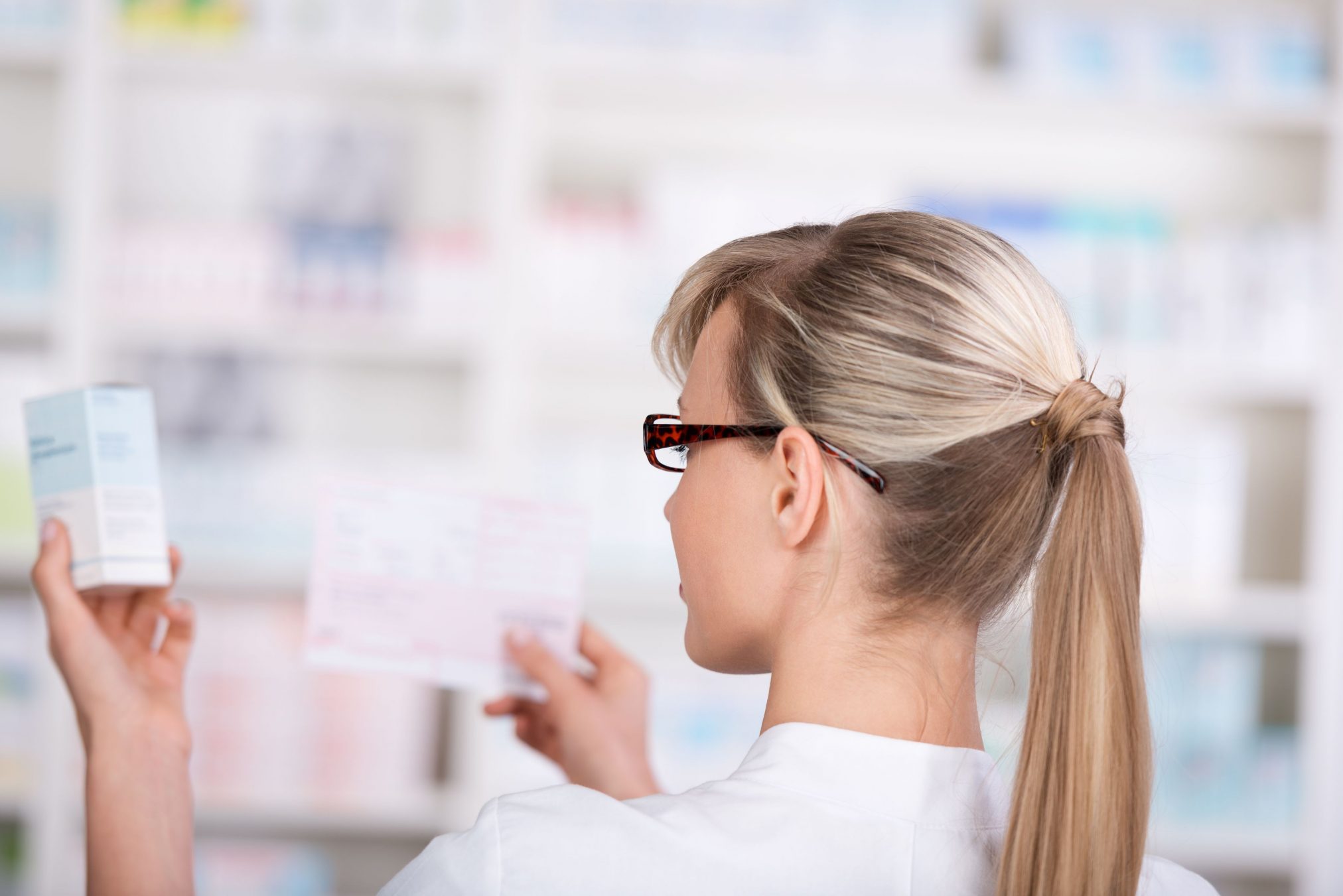 female pharmacist prescription script dispensary