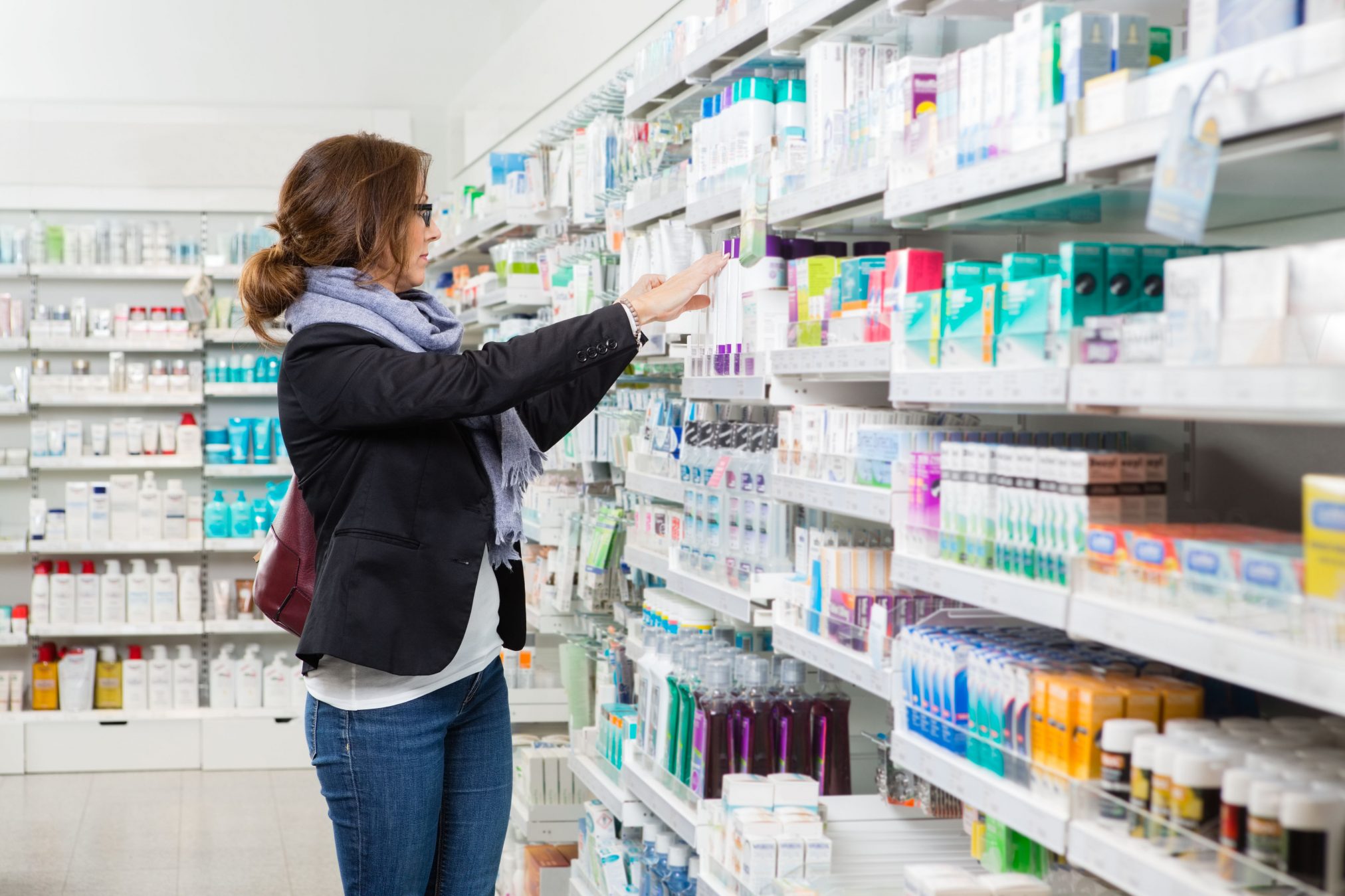woman shopping in pharmacy products beauty retail personal care