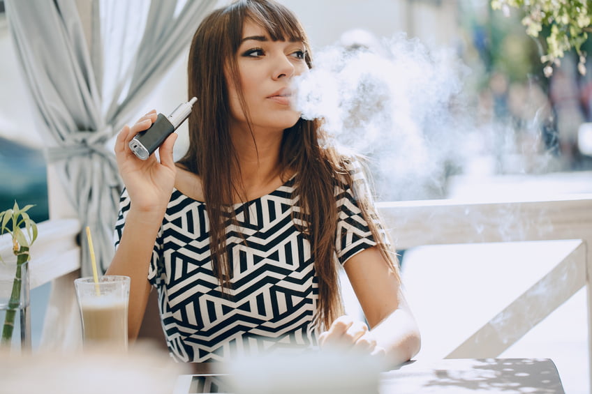 woman vaping in a restaurant
