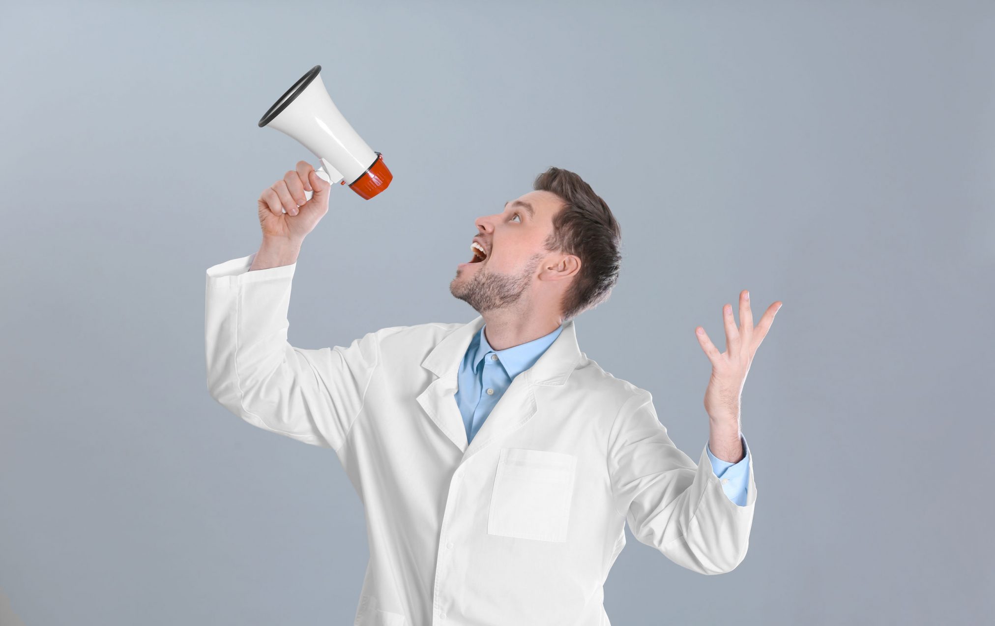 white coat professional shouting into megaphone