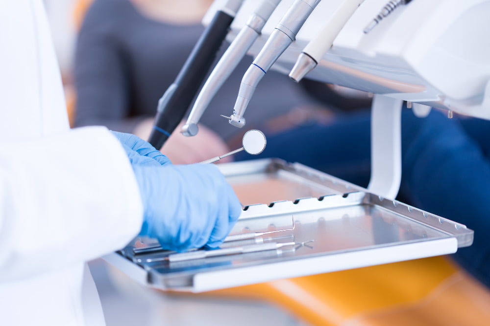 dentist's hands with implements