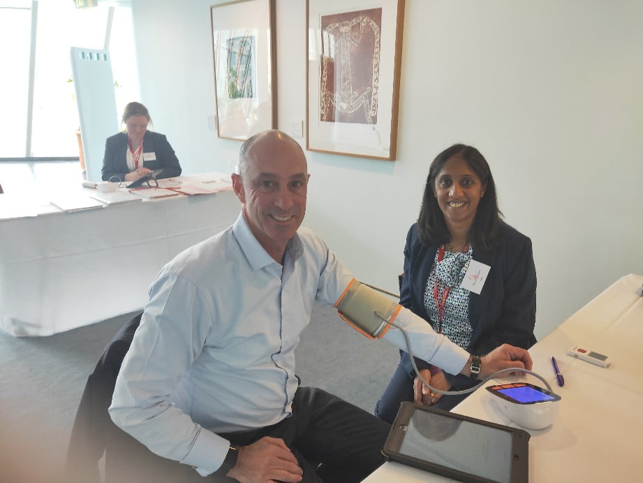 Pharmacist Bev Mistry-Cable tests Senator David Van from Victoria for an irregular heartbeat