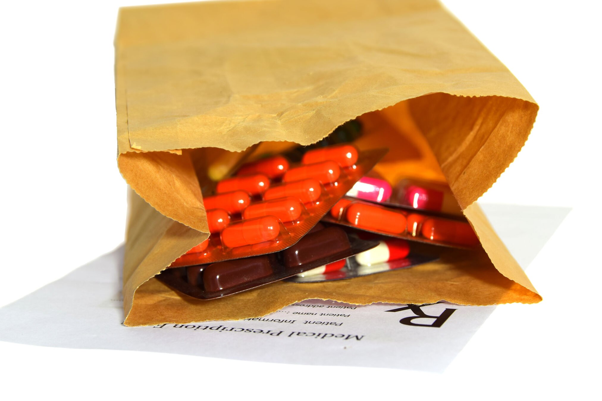 brown paper bag full of pills in blister packs