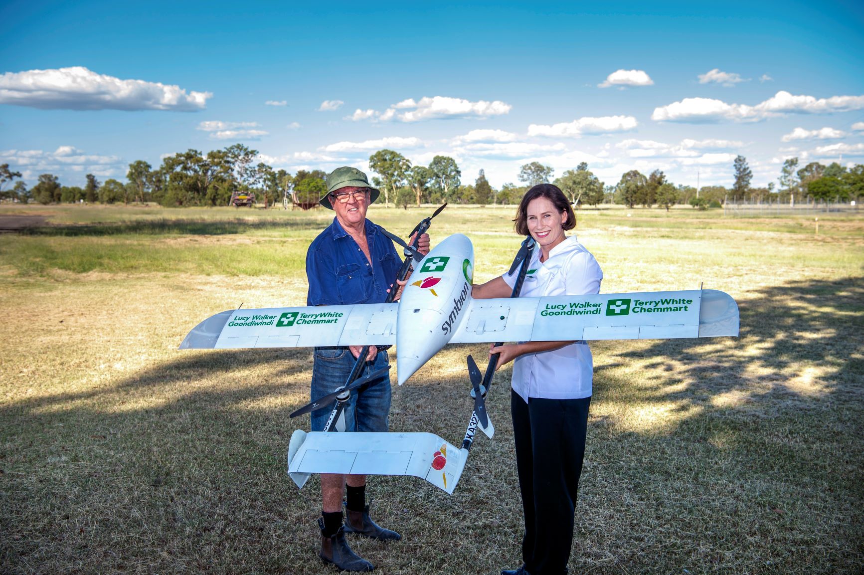 Goondiwindi local Greg Rixon with Goondiwindi Terry White Chemmart Pharmacist Lucy Walker and drone.