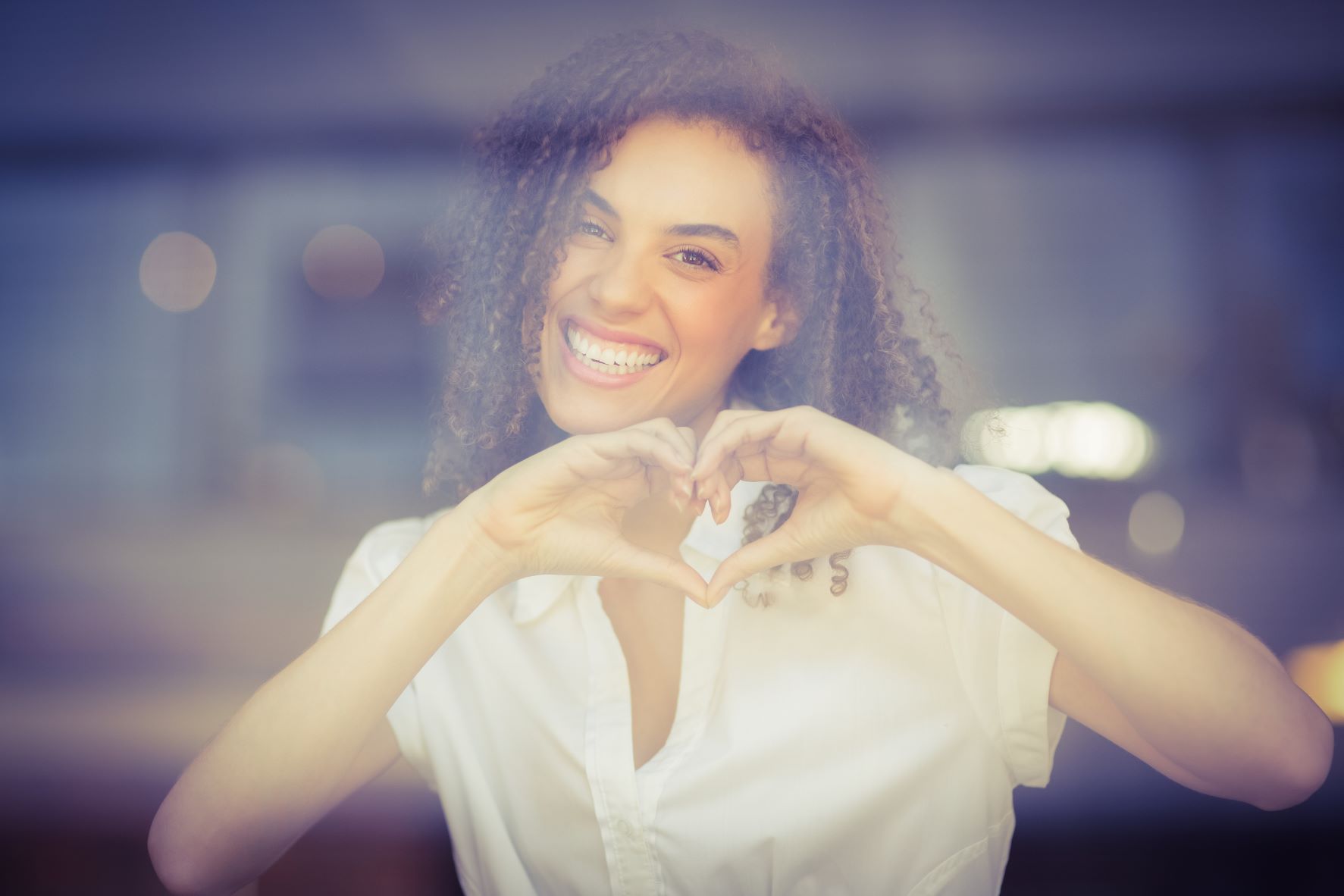 woman making heart shape with hands