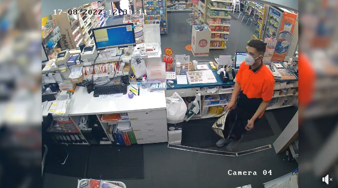 man in surgical mask with knife and bag, in pharmacy dispensary